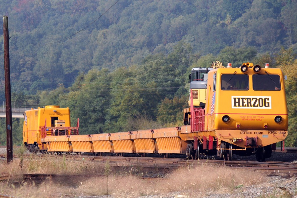 This Herzog material handling train pulled out of the yard tracks while the helper drama was playing out in the background.