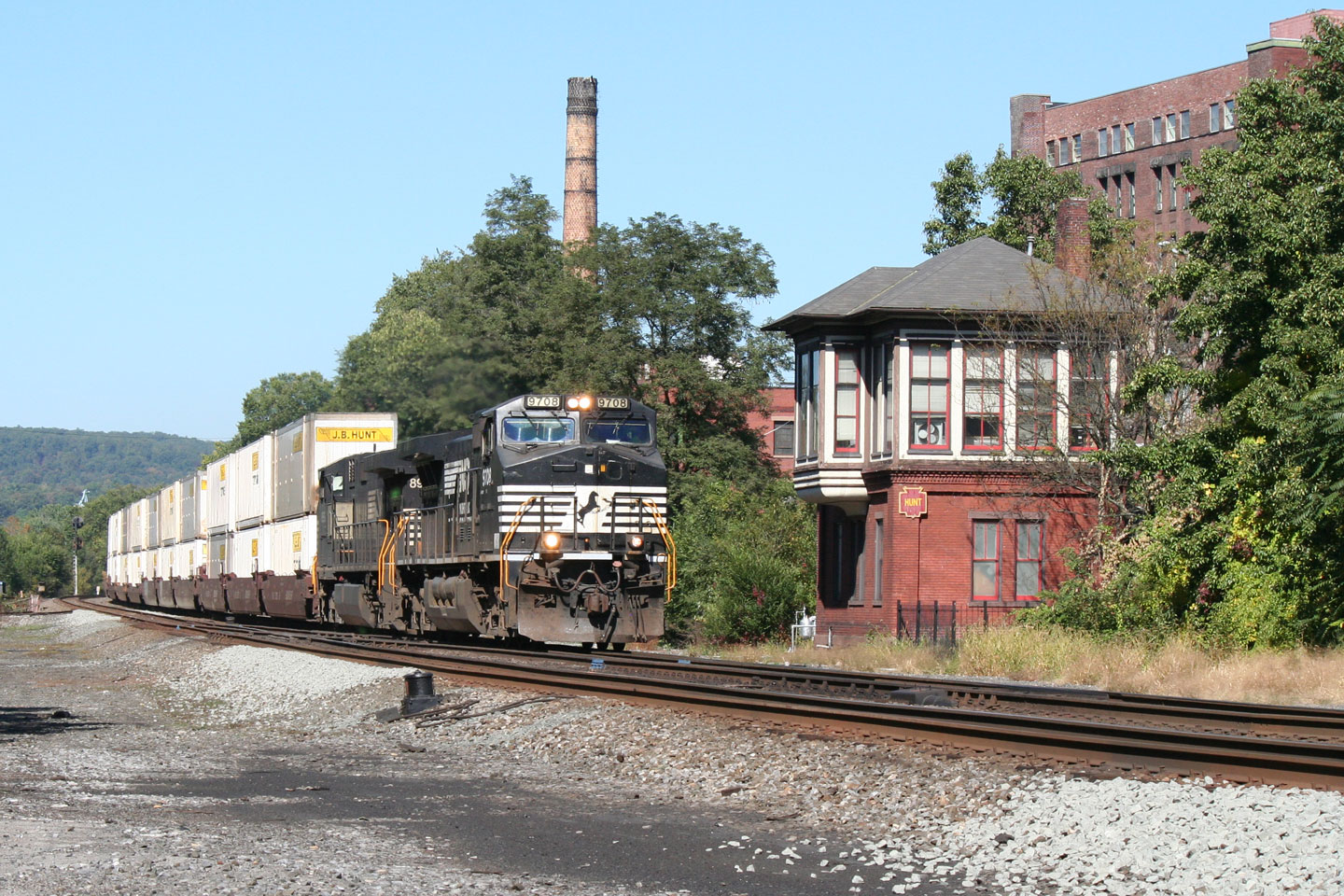 One of NS's fleet of stack trains roars past HUNT tower.