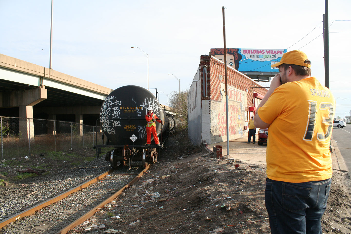 My friend Ben captures the first view of the train, emerging from behind the local businesses.